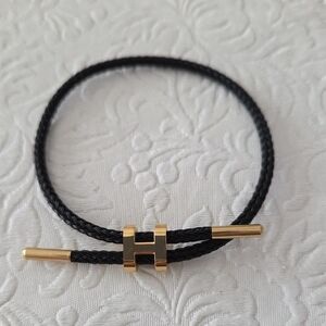 NWOT "H" Black and Gold Braided Bracelet